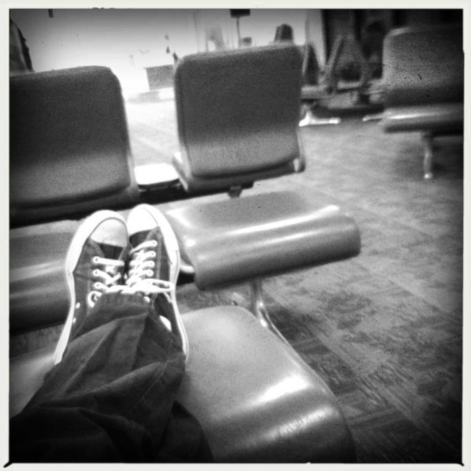 Feet up on airport seats — somewhere between assignments